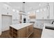 Bright kitchen features an island with storage, stainless steel appliances, white cabinets and marble countertops at 3255 Hilltop Cir, Marietta, GA 30066