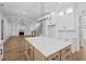 An open concept living room and kitchen with a light wood floors and a kitchen island at 3255 Hilltop Cir, Marietta, GA 30066