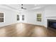Main bedroom features fireplace, tray ceiling, ceiling fan, and three windows that provide natural light at 3255 Hilltop Cir, Marietta, GA 30066