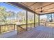 An open porch with wooden floors and a ceiling fan overlooking a wooded backyard at 3255 Hilltop Cir, Marietta, GA 30066