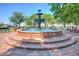 A three-tiered water fountain in the middle of a town square with mature trees and buildings around it at 3255 Hilltop Cir, Marietta, GA 30066
