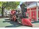 A historic steam train and railroad car on display with mature trees and buildings in the background at 3255 Hilltop Cir, Marietta, GA 30066