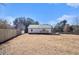 A spacious backyard with mature trees is enhanced by a classic white fence, ideal for pets at 60 Collins Rd, Carrollton, GA 30116