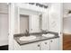 Bathroom featuring a dual sink vanity, granite counters, updated fixtures, and bright lighting at 60 Collins Rd, Carrollton, GA 30116