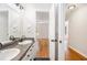 Bright bathroom with dual sinks, granite countertops, and hardwood floors leading to the bedroom at 60 Collins Rd, Carrollton, GA 30116
