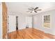 This spacious bedroom features hardwood floors, lots of light, and rustic wood accent wall at 60 Collins Rd, Carrollton, GA 30116