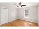 Cozy bedroom featuring a ceiling fan, a window, and a spacious closet for ample storage at 60 Collins Rd, Carrollton, GA 30116