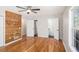 Bedroom showcasing hardwood floors, neutral walls, and an artistic wooden accent wall feature at 60 Collins Rd, Carrollton, GA 30116