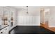 Dining area with modern accent wall, stylish lighting and doors to backyard deck at 60 Collins Rd, Carrollton, GA 30116