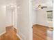 Hallway with hardwood flooring leading into a bedroom with natural light and a ceiling fan at 60 Collins Rd, Carrollton, GA 30116