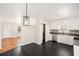 Modern kitchen with white cabinets, dark countertops, and stylish light fixture at 60 Collins Rd, Carrollton, GA 30116