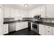 Beautiful kitchen with stainless appliances, neutral backsplash and white cabinetry at 60 Collins Rd, Carrollton, GA 30116