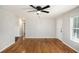 Open-concept living area with hardwood floors, white walls, and modern ceiling fan at 60 Collins Rd, Carrollton, GA 30116