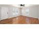 Bright living room featuring hardwood flooring, neutral walls, and ceiling fan at 60 Collins Rd, Carrollton, GA 30116