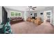 Large bonus room with a ceiling fan, multiple seating options and a window with natural light at 1605 Camden Cove Dr, Cumming, GA 30040