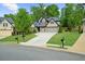 Charming two-story home featuring a well-manicured lawn and a three-car garage at 1605 Camden Cove Dr, Cumming, GA 30040