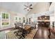 Bright living room with large windows, stylish seating, and a seamless flow into the kitchen area at 1605 Camden Cove Dr, Cumming, GA 30040