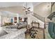 Inviting living room featuring high ceilings, a ceiling fan, comfortable sofas, and elegant stairway at 1605 Camden Cove Dr, Cumming, GA 30040