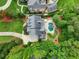 Aerial view of the property showcasing the backyard pool and surrounding trees at 4992 Price Dr, Suwanee, GA 30024