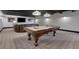 Basement game room with a pool table, TV, and leather seating at 4992 Price Dr, Suwanee, GA 30024