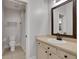 Clean bathroom with single vanity, framed mirror, toilet, and shower with curtain at 4992 Price Dr, Suwanee, GA 30024