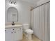 This is a bathroom with a shower, sink, toilet, mirror, and white cabinets at 4992 Price Dr, Suwanee, GA 30024