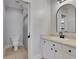 This is a bathroom with a shower, sink, toilet, mirror, and white cabinets at 4992 Price Dr, Suwanee, GA 30024