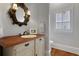 Charming bathroom with antique vanity and rustic wood flooring, plus shuttered window at 4992 Price Dr, Suwanee, GA 30024