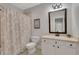 Bathroom featuring a vanity with black hardware, a shower and a framed inspirational quote at 4992 Price Dr, Suwanee, GA 30024