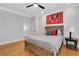 This is a bedroom with a ceiling fan, wooden bed and floors and sports decor at 4992 Price Dr, Suwanee, GA 30024