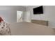 Neutral bedroom featuring a dresser, mounted TV, and an ensuite bathroom at 4992 Price Dr, Suwanee, GA 30024
