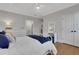 This is a bedroom with a blue bedspread, white floors, and hardwood floors at 4992 Price Dr, Suwanee, GA 30024