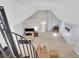 High angle view of bonus room with bed, sitting area and spiral staircase at 4992 Price Dr, Suwanee, GA 30024