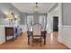 Dining room with wainscoting, hardwood floors, and stylish lighting at 4992 Price Dr, Suwanee, GA 30024