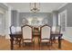Dining room with a dining table, hardwood floors, and stylish lighting at 4992 Price Dr, Suwanee, GA 30024