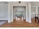 Inviting foyer with hardwood floors and elegant white columns that open to the living room at 4992 Price Dr, Suwanee, GA 30024