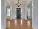 Elegant foyer with hardwood floors and a stylish pendant light at 4992 Price Dr, Suwanee, GA 30024
