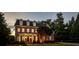 Elegant brick home with dormer windows and manicured lawn at 4992 Price Dr, Suwanee, GA 30024
