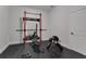 Home gym features squat rack, weight bench, free weights, rubber flooring and access to storage and utilities at 4992 Price Dr, Suwanee, GA 30024