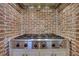 Modern kitchen with stainless steel Dacor gas range cooktop inside a brick alcove at 4992 Price Dr, Suwanee, GA 30024