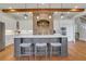 Kitchen island with bar stool seating and stainless steel appliances with brick oven alcove at 4992 Price Dr, Suwanee, GA 30024