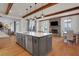 Open kitchen with large island and stainless steel dishwasher overlooking the fireplace at 4992 Price Dr, Suwanee, GA 30024