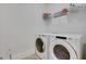 Bright laundry room with modern washer and dryer and storage shelves at 4992 Price Dr, Suwanee, GA 30024