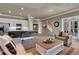Open living room with bar, kitchen, brick floors and natural light at 4992 Price Dr, Suwanee, GA 30024