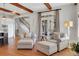 Comfortable living room featuring hardwood floors, wooden beams, and cozy seating with access to outdoor space at 4992 Price Dr, Suwanee, GA 30024