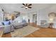Spacious and bright living room with staircase, clock, and hardwood floors at 4992 Price Dr, Suwanee, GA 30024