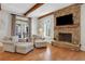 Cozy living room with fireplace and wooden beam ceilings at 4992 Price Dr, Suwanee, GA 30024