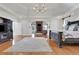 Bright main bedroom with hardwood floors, fireplace, and a seating area for relaxation at 4992 Price Dr, Suwanee, GA 30024