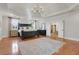 Spacious main bedroom features a tray ceiling, a chandelier, and hardwood flooring at 4992 Price Dr, Suwanee, GA 30024