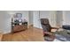 This is an office with a leather chair, wooden console table, and hardwood floors at 4992 Price Dr, Suwanee, GA 30024